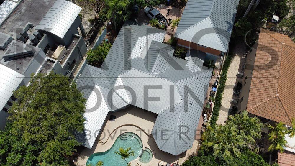 aerial drone picture of silver metal roof on florida home by Kairos Roofing