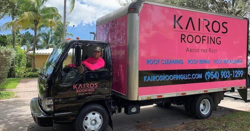 Friendly and professional roofers driving the Kairos Roofing truck around South Florida