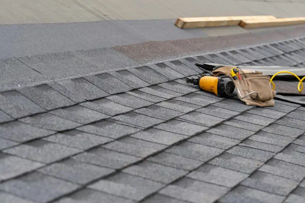 Nail Gun Lying on Asphalt Shingle