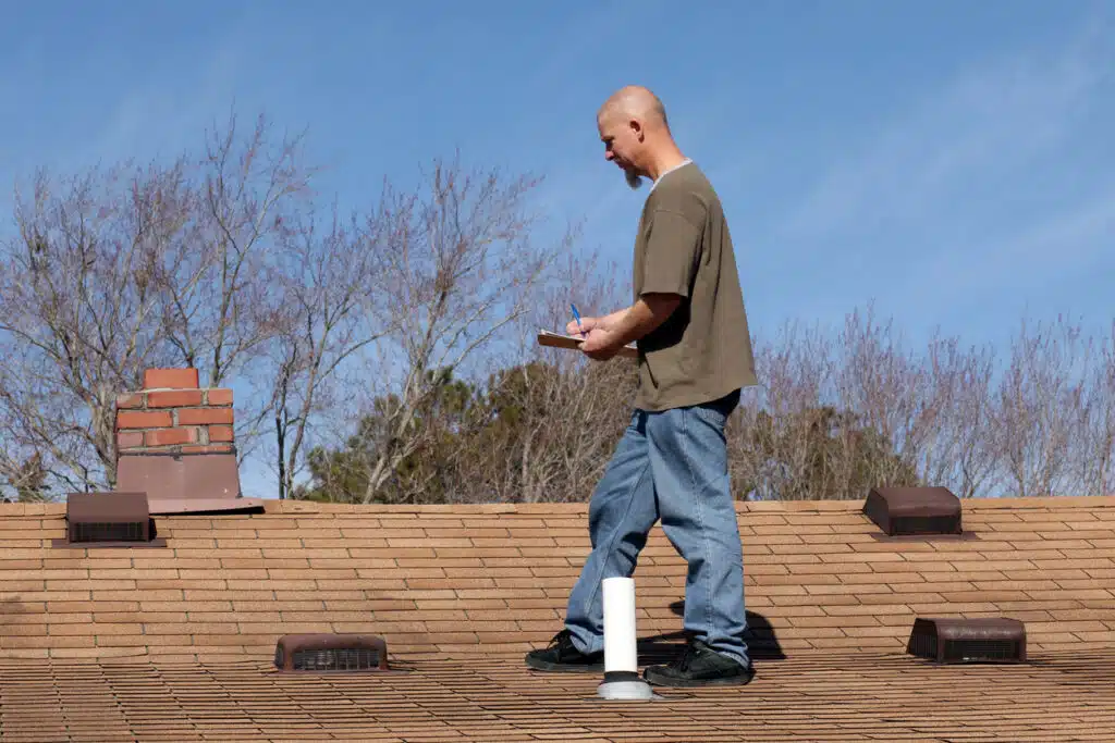 Man Inspecting Roof